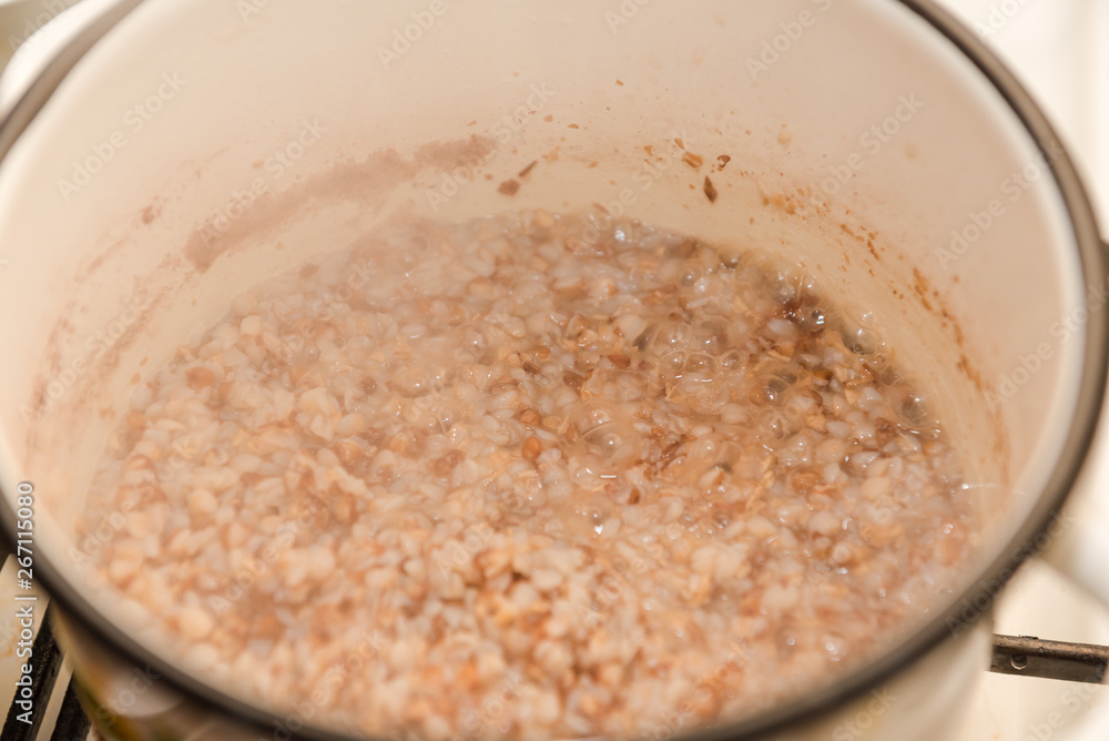 Boil buckwheat. Buckwheat stew in a saucepan. Homemade food. Homemade cooking buckwheat. Boil buckwheat. Buckwheat stew in a saucepan. Homemade food. Homemade cooking buckwheat.
