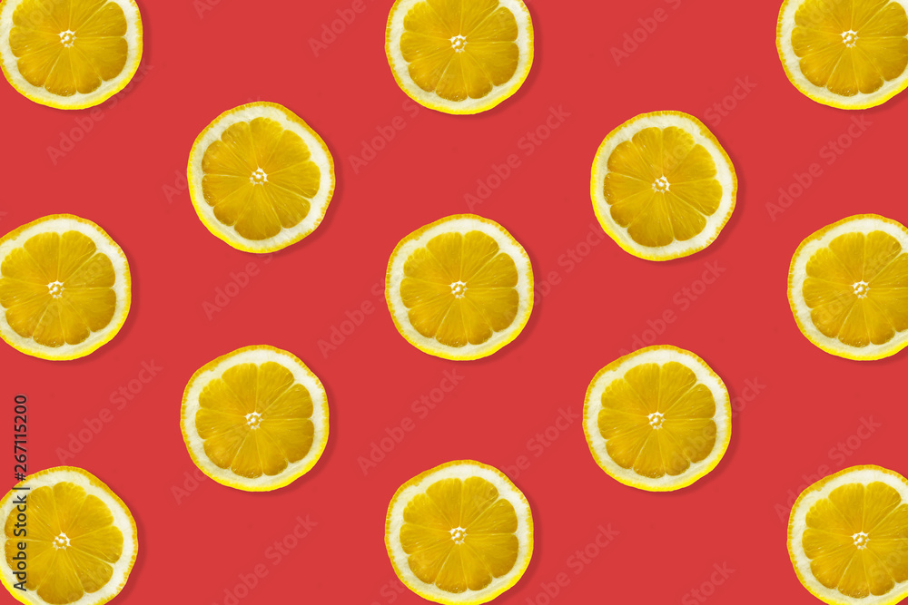 Creative pattern made of lemon. top view of fruit fresh limes slices on red colorful background. Creative pattern made of lemon. top view of fruit fresh limes slices on red colorful background.