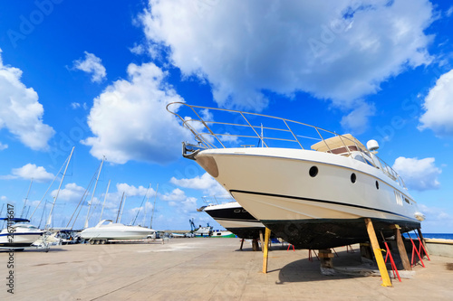 Luxury motor yacht beached on a dry dock for painting and repair
