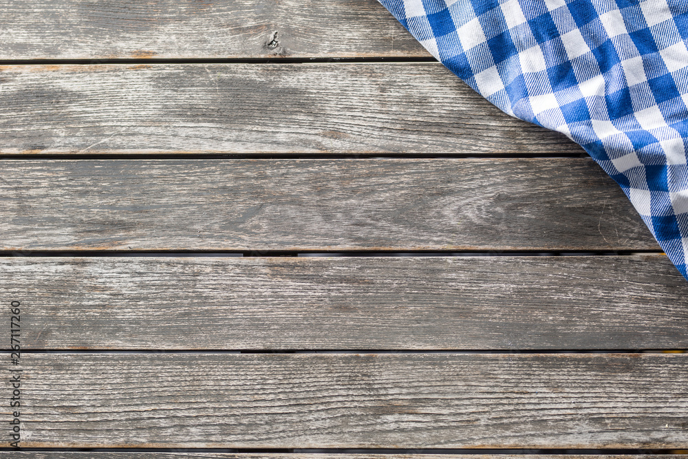 Blue white checketed tablecloth on wooden kitchen table - top of view Blue white checketed tablecloth on wooden kitchen table - top of view