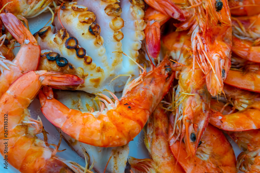 Fresh grilled shrimps and octopus on the dish, prawns. Fresh grilled shrimps and octopus on the dish, prawns.