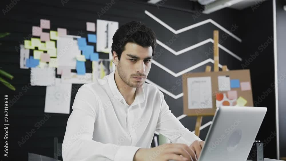 Angry businessman looking to the camera sitting in his workplace. Angry businessman looking to the camera sitting in his workplace.