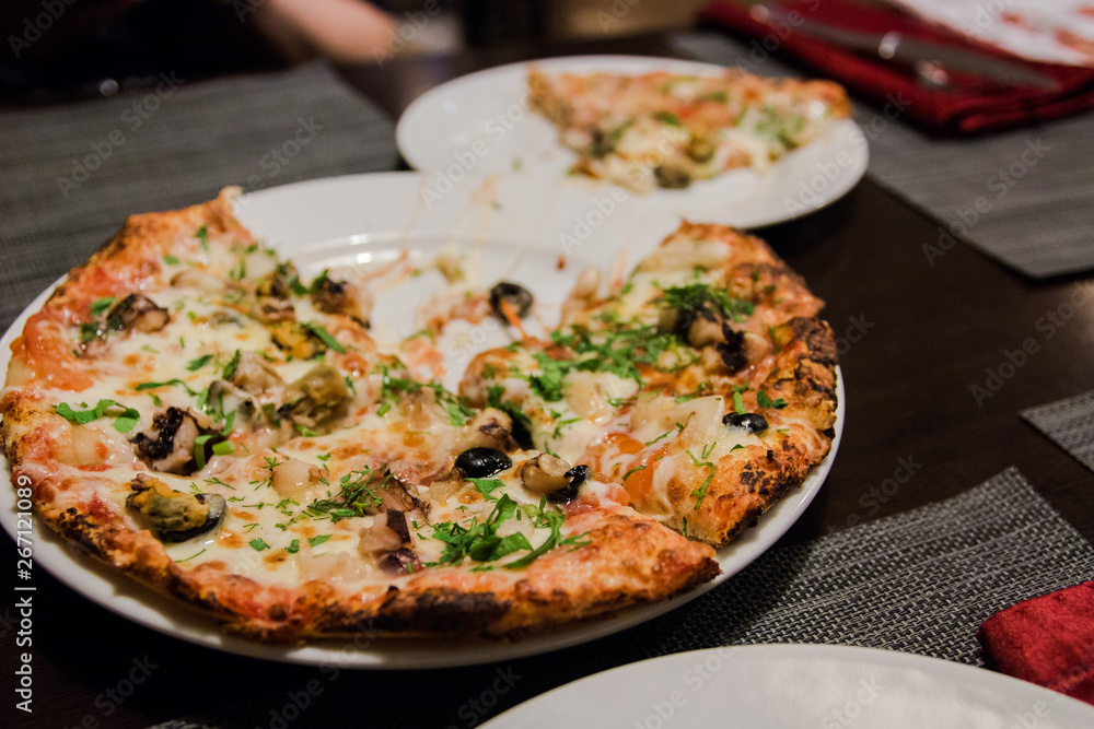 Pizza with seafood with melted cheese and herbs sprinkled on top Pizza with seafood with melted cheese and herbs sprinkled on top