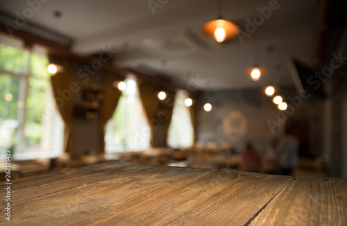 Empty wooden table in front of abstract blurred background of coffee shop . can be used for display or montage your products.Mock up for display of product