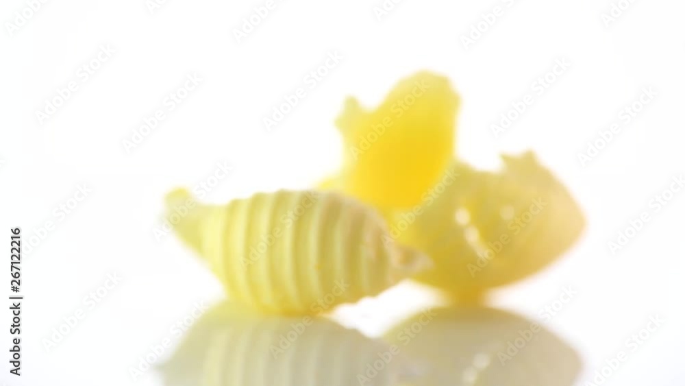 Butter. Curls of fresh natural butter rotated on a white background. 4K UHD video footage. 3840X2160 Butter. Curls of fresh natural butter rotated on a white background. 4K UHD video footage. 3840X2160