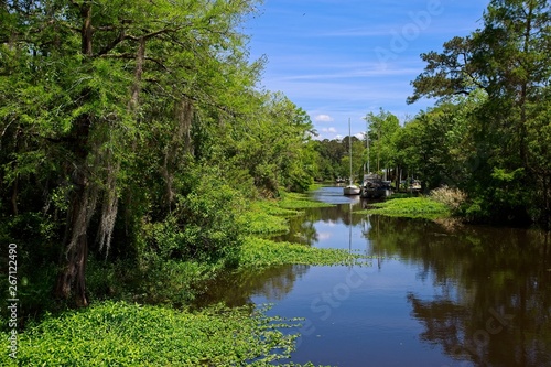 Boats parked along a canal on a sunny spring day in Bayou De Zaire located in Madisonville, Louisiana photo
