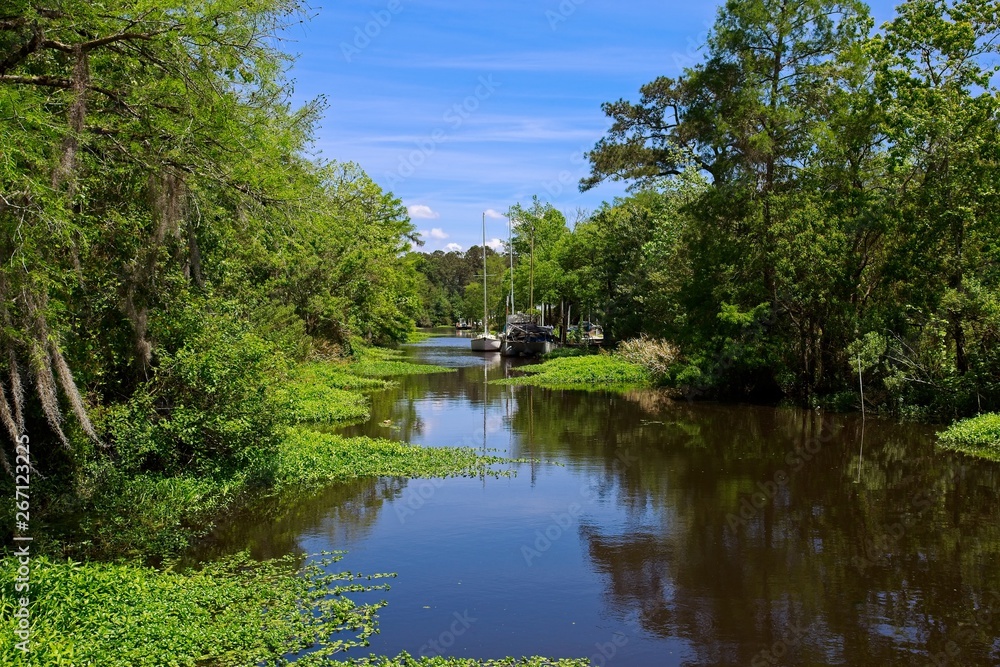 Boats parked along a canal on a sunny spring day in Bayou De Zaire located in Madisonville, Louisiana