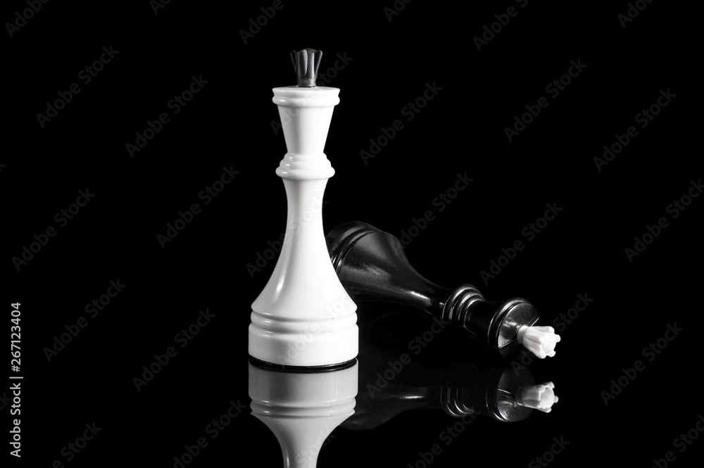 White and black chess kings on black reflective background. White and black chess kings on black reflective background.