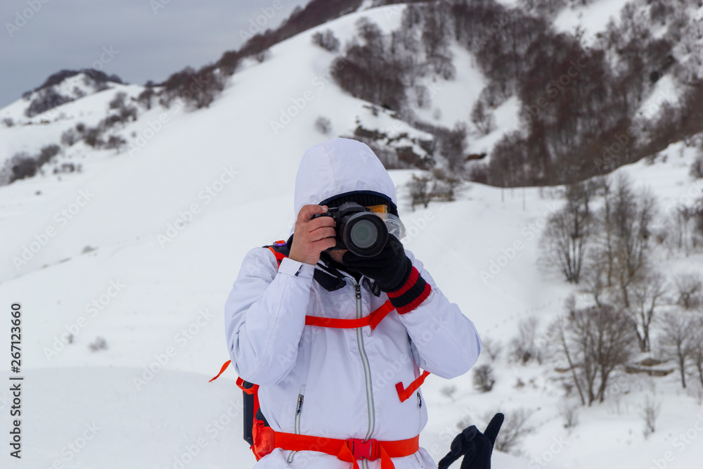 hiker take photo on snow