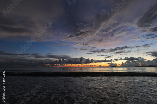 Scenic sunset over ocean beach.