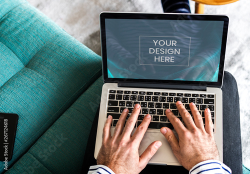 Person Using Laptop Mockup on a Sofa