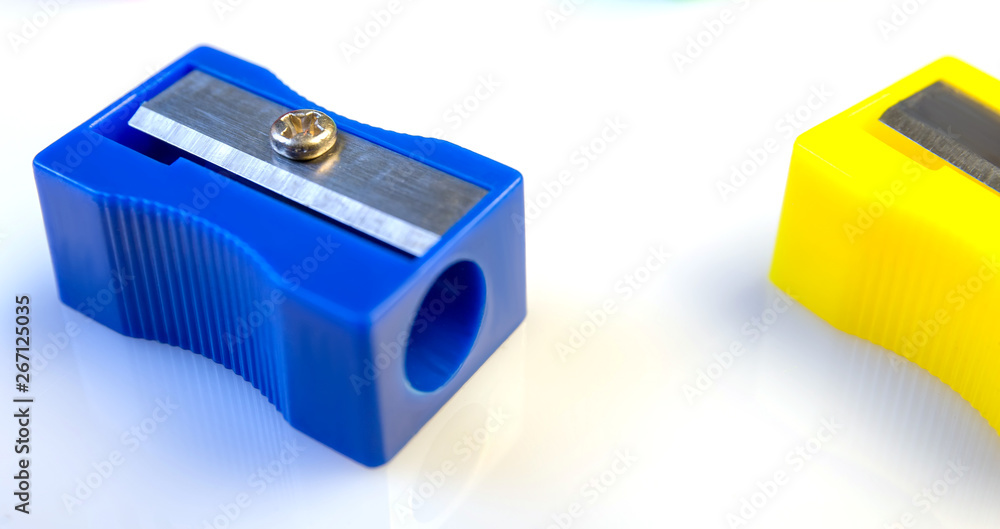 Large pencil sharpener on a white isolated background, close-up with space for the text. Large pencil sharpener on a white isolated background, close-up with space for the text.