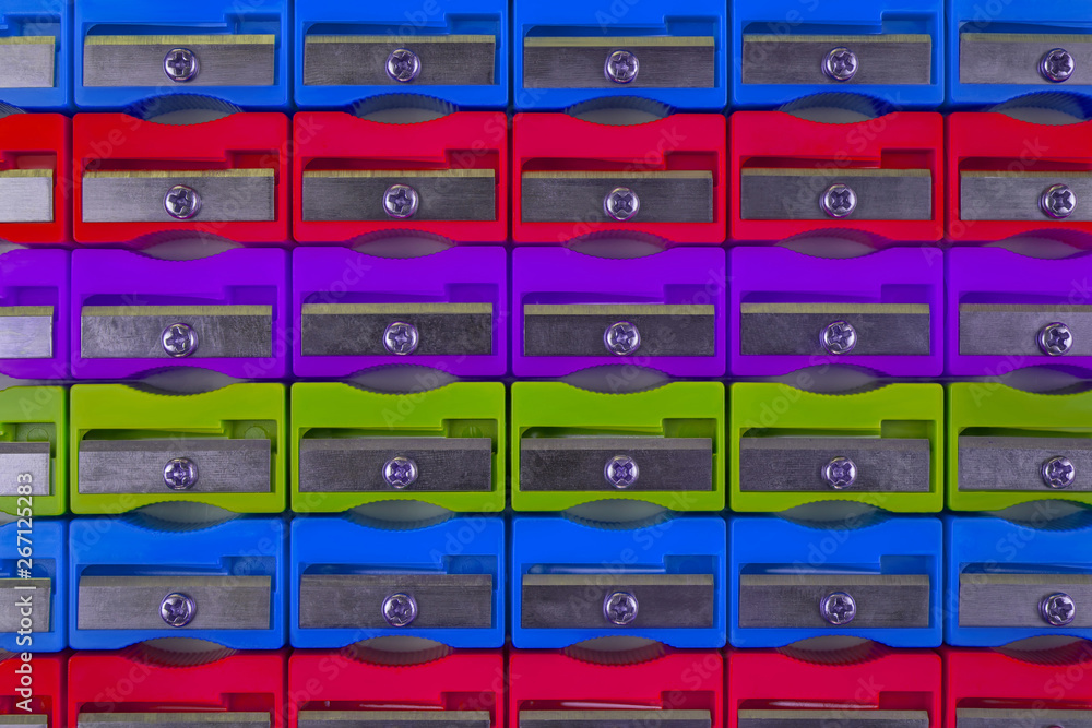 The concept of holidays in school. Texture of multicolored pencil sharpeners, close-up, flat lay with space for text The concept of holidays in school. Texture of multicolored pencil sharpeners, close-up, flat lay with space for text