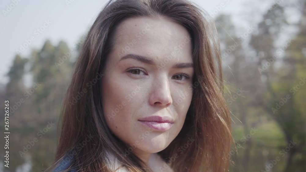 Close up portrait of pretty young glamour smiling woman looking in the camera. Beautiful landscape on background. Close up portrait of pretty young glamour smiling woman looking in the camera. Beautiful landscape on background.