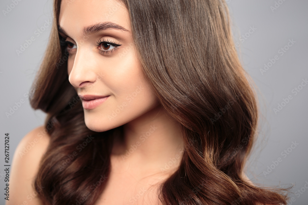 Brunette girl with healthy curly hair and natural make up . Beautiful model woman with wavy hairstyle .Care and beauty Brunette girl with healthy curly hair and natural make up . Beautiful model woman with wavy hairstyle .Care and beauty