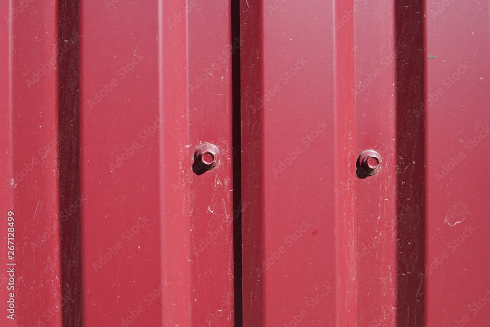 Background striped red metal profile. Texture of painted red metal surface Background striped red metal profile. Texture of painted red metal surface