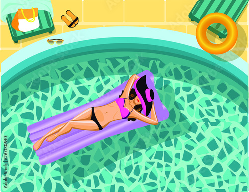 beautiful girl swims on an inflatable mattress in the pool