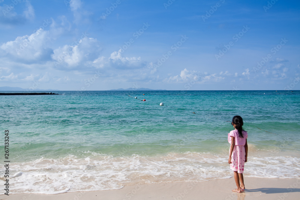 Small girl looking out the ocean