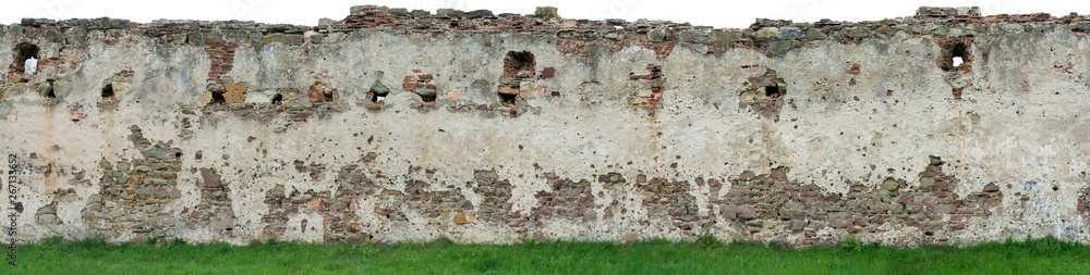 The high resolution texture of the old brick wall with showered plaster and clay putty with green grass. Useful for the texture of the old castle or walls in design, architecture and game development The high resolution texture of the old brick wall with showered plaster and clay putty with green grass. Useful for the texture of the old castle or walls in design, architecture and game development