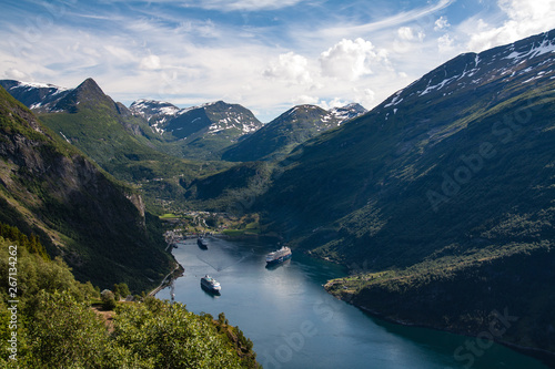 Ferry boats on lake surrounded by mountains