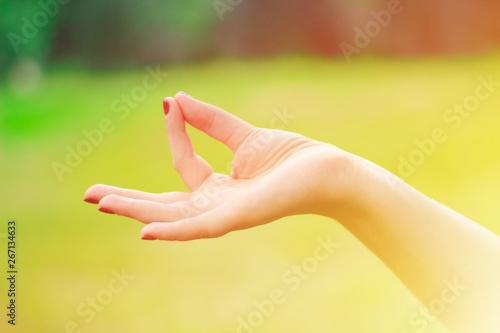  peace and meditation concept. Calm  young woman practices yoga indoor, shows okay sign with both hands, demonstrates approval © AnnyStudio