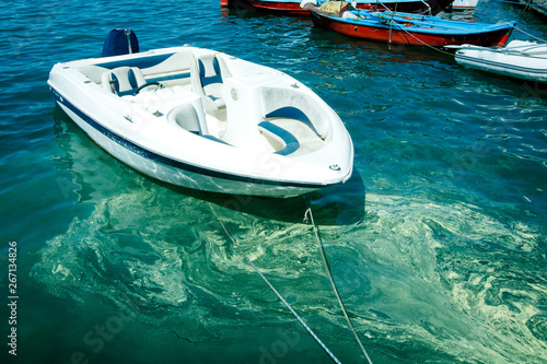 small white motor boat on the water in the sea