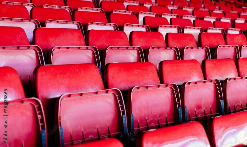 Obraz premium Red plastic empty stadium seats.