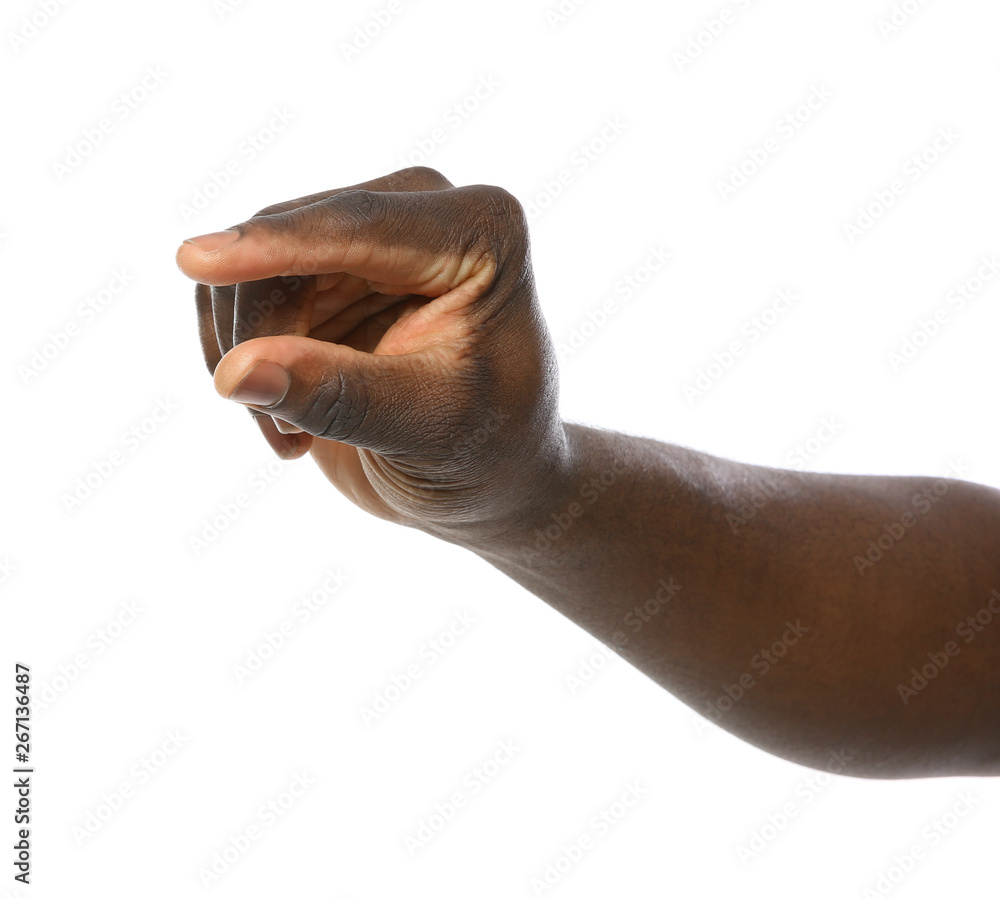 Fototapeta premium African-American man holding something in hand on white background, closeup
