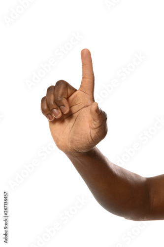 African-American man pointing at something on white background, closeup