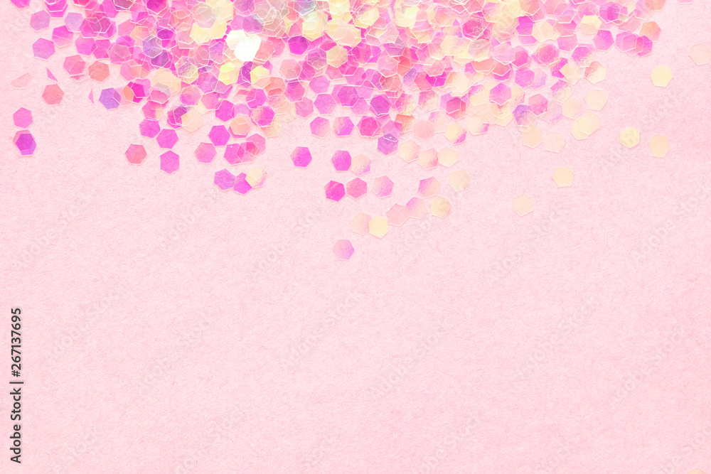 Confetti  on pink paper background, festive concept.  Perfect place for your design.
