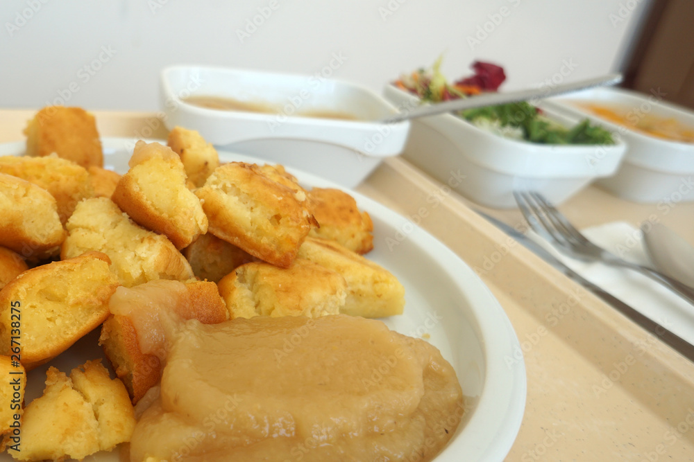 Sugared pancake with stewed plums with apple compote Fruit salad and green salad served on the tray Sugared pancake with stewed plums with apple compote Fruit salad and green salad served on the tray