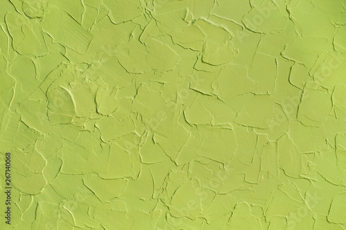 Green pistachio color, textured background, wavy plaster
