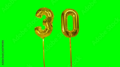 Number 30 thirty years birthday anniversary gold balloon floating on green screen