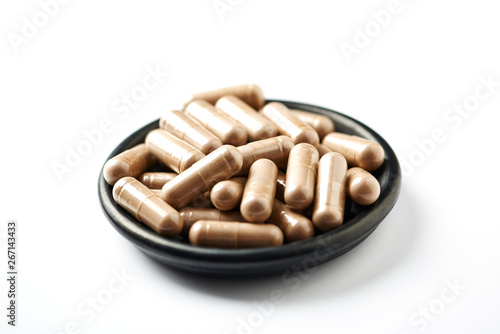 Reishi Mushroom capsules. Concept for a healthy dietary supplementation. White background. Close up. 