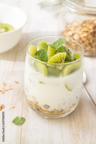 Yogurt, granola and kiwi in glass