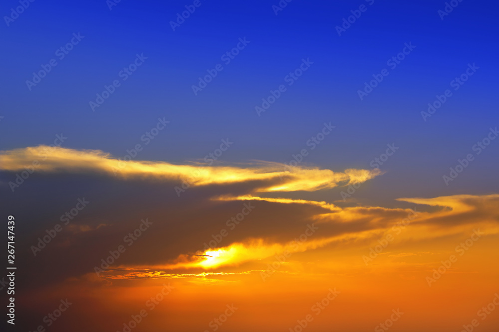 Beautiful cloudscape of colorful sunset sky with shining sun