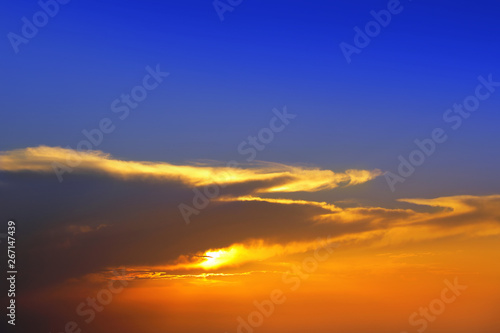 Beautiful cloudscape of colorful sunset sky with shining sun