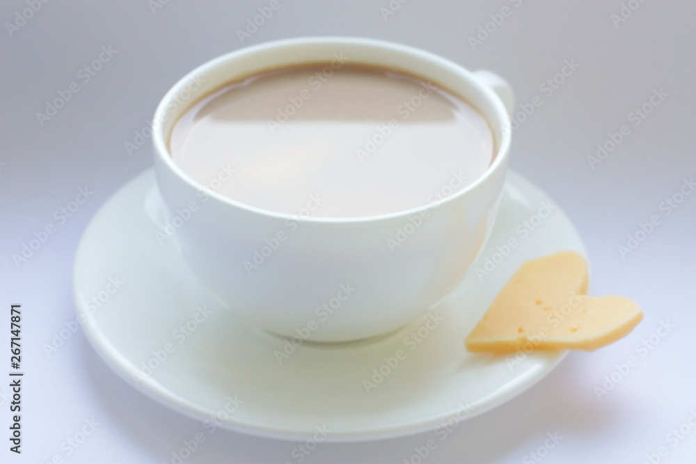White porcelain cup. Coffee with milk. A cup on the window and a slice of cheese. Love. Morning. White porcelain cup. Coffee with milk. A cup on the window and a slice of cheese. Love. Morning.