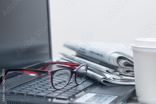 The concept of news. Laptop, newspaper, desktop businessman, freelancer, student.