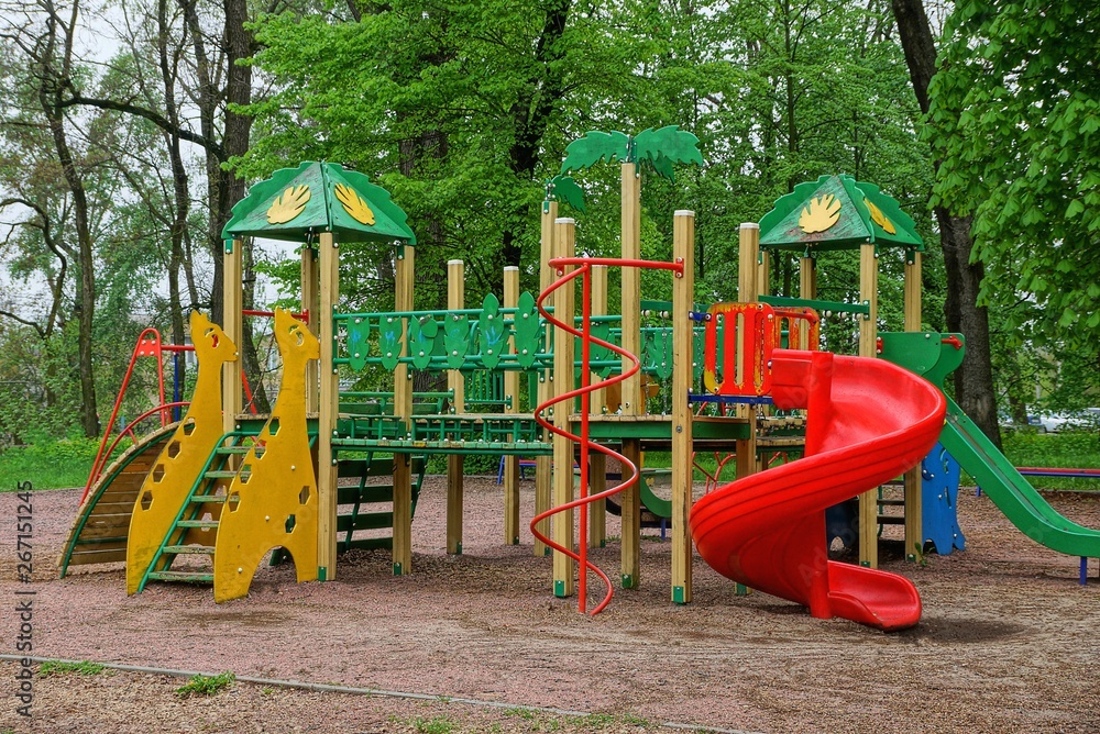 color structure on the playground in the park among green trees color structure on the playground in the park among green trees
