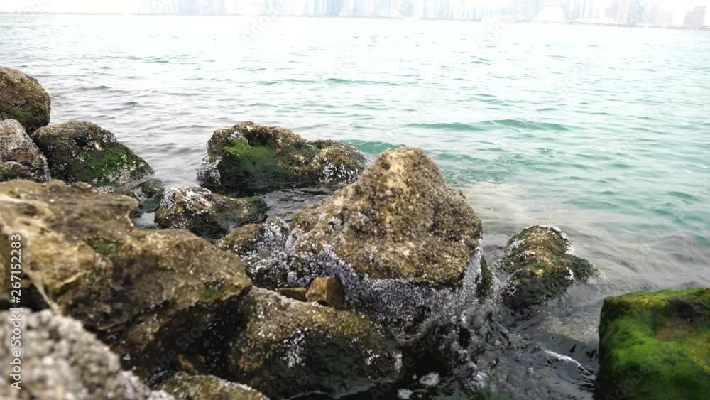 Stones and rocks covered by moss along water and sea waves near Corniche Doha Bay, Doha, Qatar, Middle East Stones and rocks covered by moss along water and sea waves near Corniche Doha Bay, Doha, Qatar, Middle East