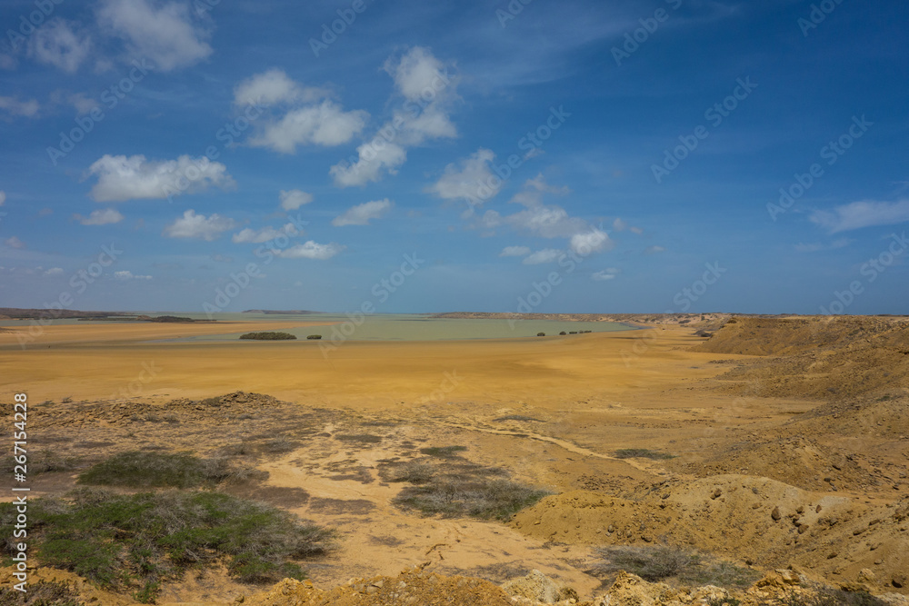 Yellow, brown desert and bay near Punta Gallinas in La Guajira, Colombia Yellow, brown desert and bay near Punta Gallinas in La Guajira, Colombia