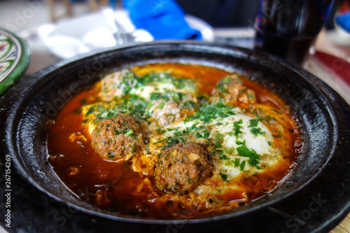 kofta tajine, kefta tagine, moroccan cuisine, lamb meatballs with eggs served in a restaurant in Marrakech, Morocco