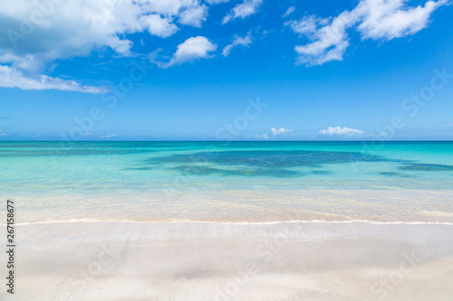 Looking out to sea from an idyllic sandy beach on the island of Antigua