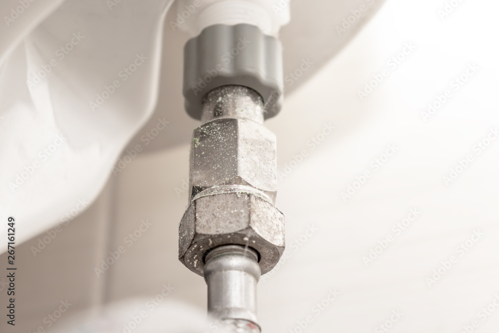 Water supply fitting of cistern tank of the toilet bowl at water closet close up Water supply fitting of cistern tank of the toilet bowl at water closet close up