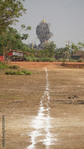 Kyaut Ka Latt Pagoda in a dry mountain landscape near Hpa-An, Burma, Myanmar.  photo