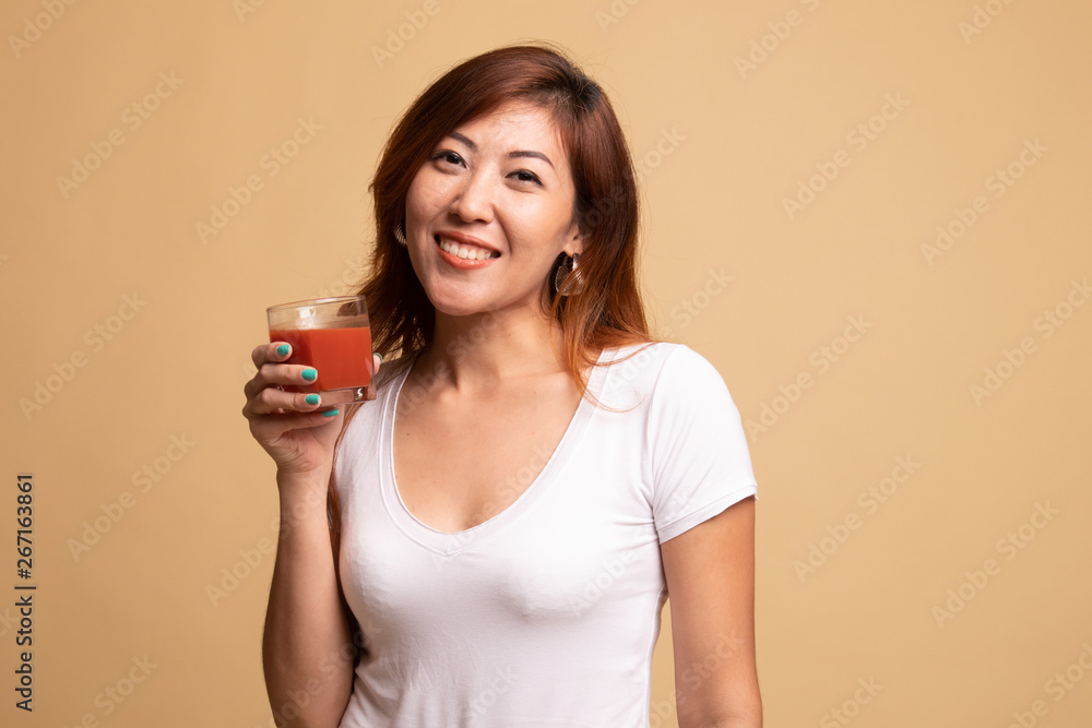 Young Asian woman drink tomato juice. Young Asian woman drink tomato juice.