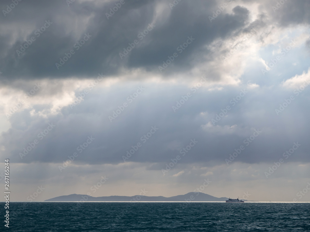 Ferry and Hills on the horizon next to the island of Koh Phangan.Thailand.