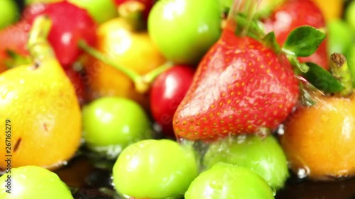 water is pouring over strawberries and fruits