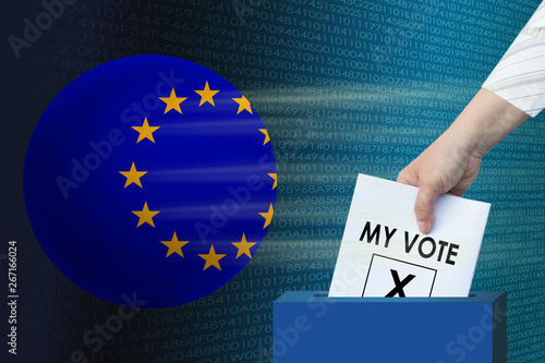 female right hand lowers a white sheet, the symbol of an election ballot with an inscription in English "my vote" in the ballot box on the background of a globe with the flag of the European Union